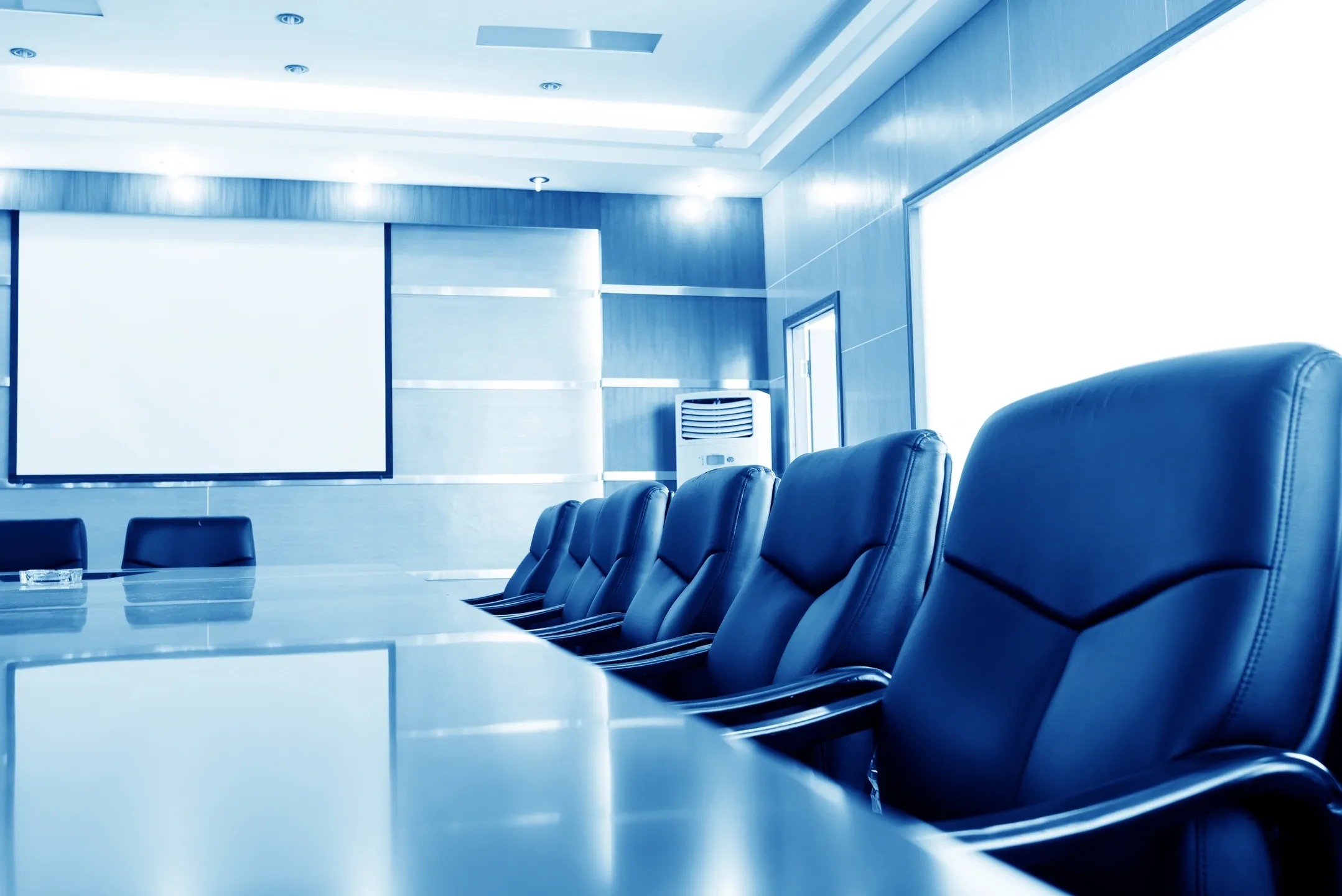 A conference room with many chairs and tables.