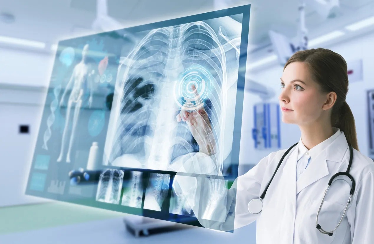 A doctor is looking at an x-ray on the screen.